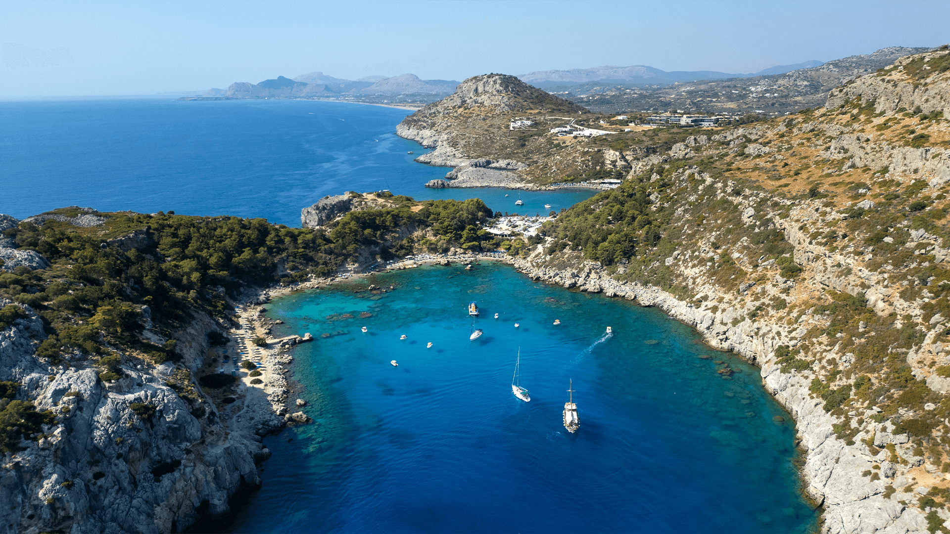 Clear water and rocky cove at Anthony Quinn Bay on a Rhodes yacht charter